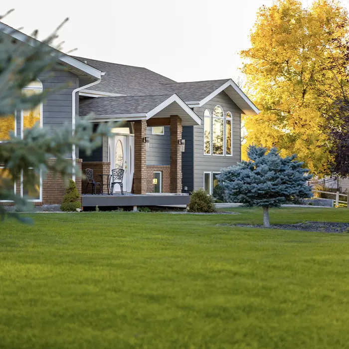 Single-family home with a green front lawn and foundation plantings